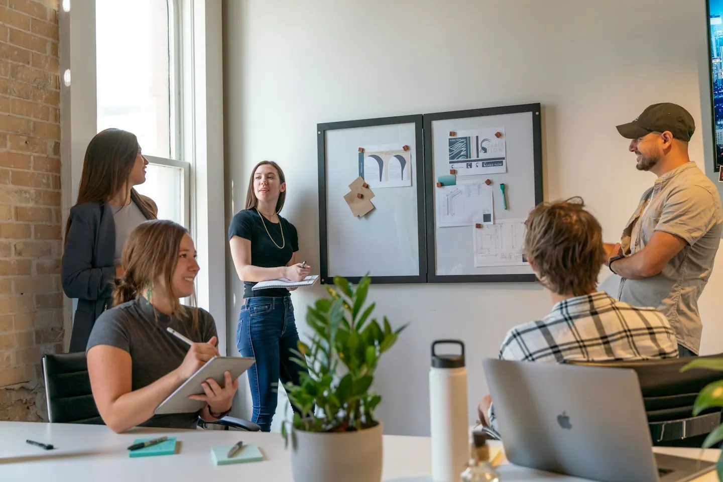People collaborating in a sunlit workspace