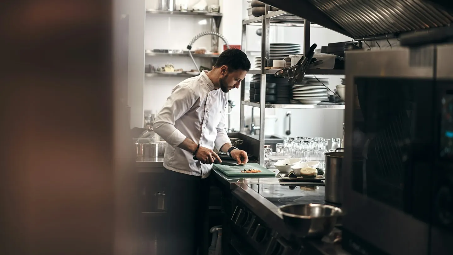 Chef chopping ingredients in a restaurant kitchen