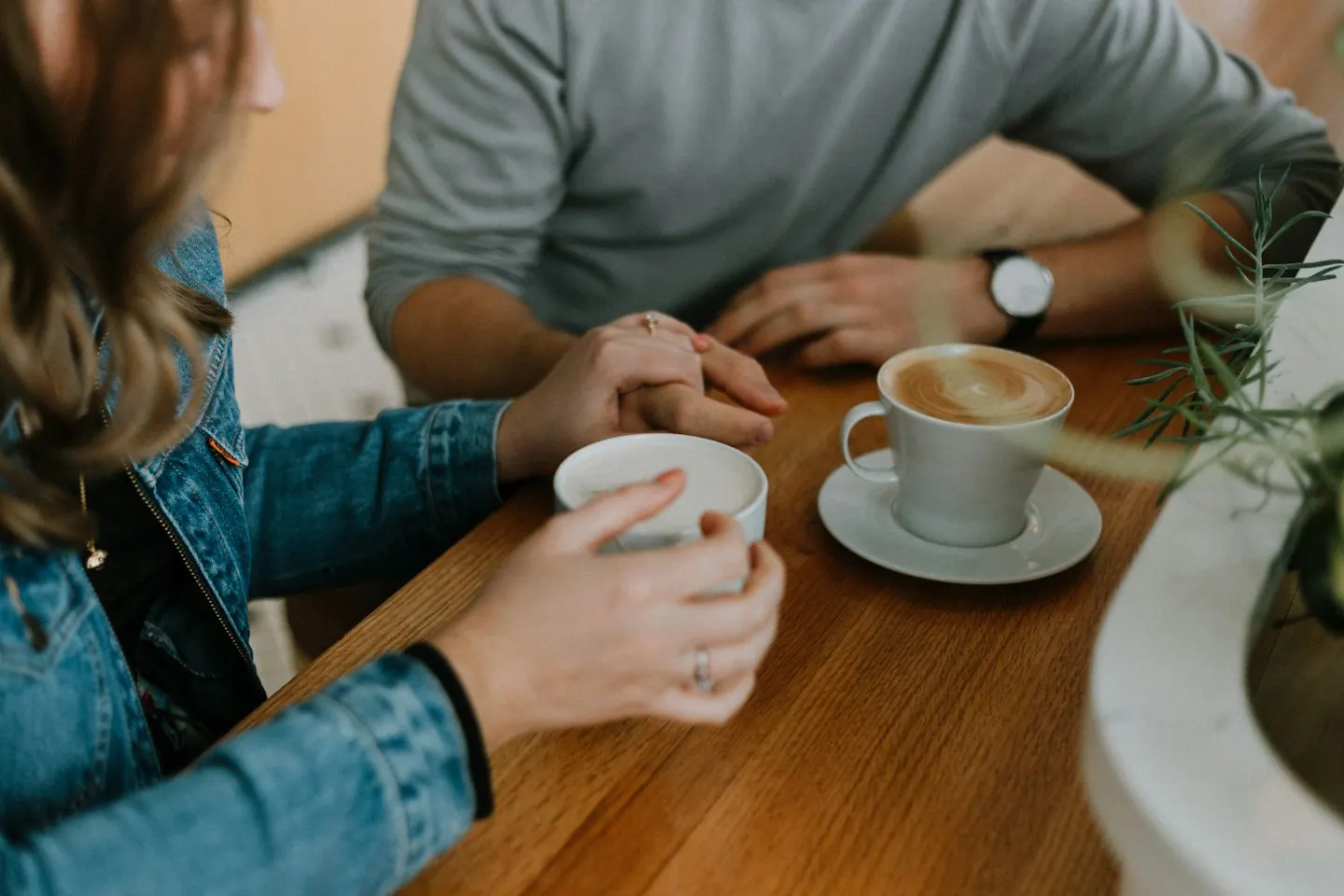 Two people sharing coffee at a table