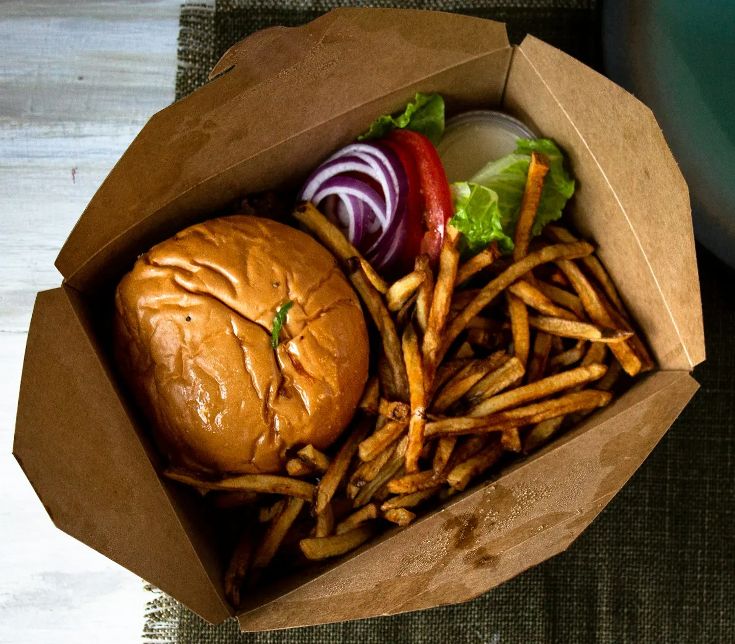 Burger and fries served on paper