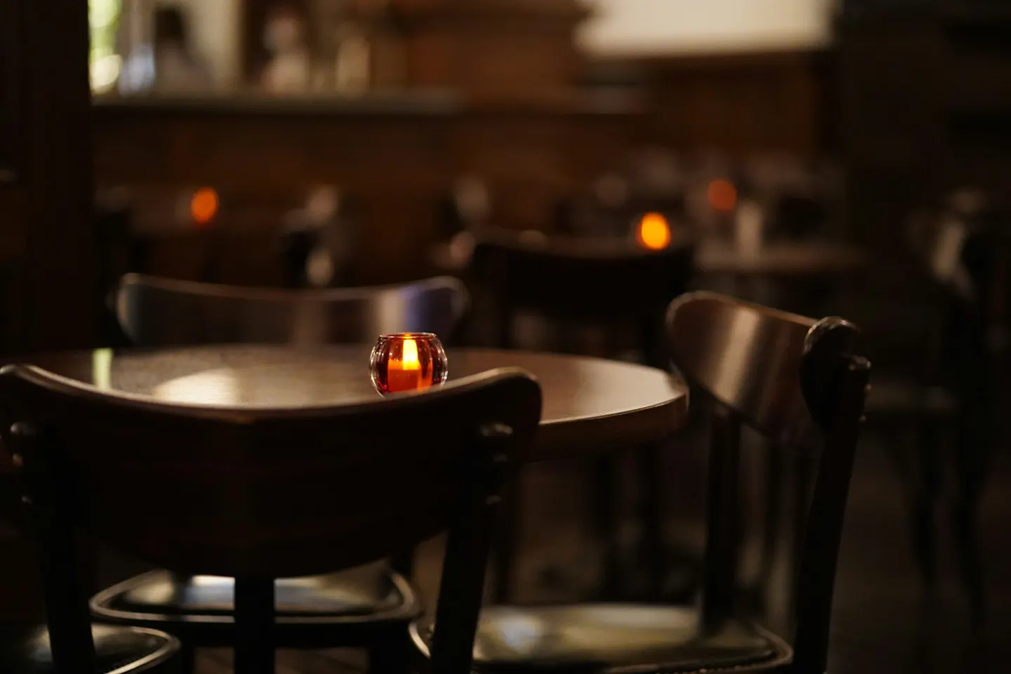 Candlelit table in a dim dining room