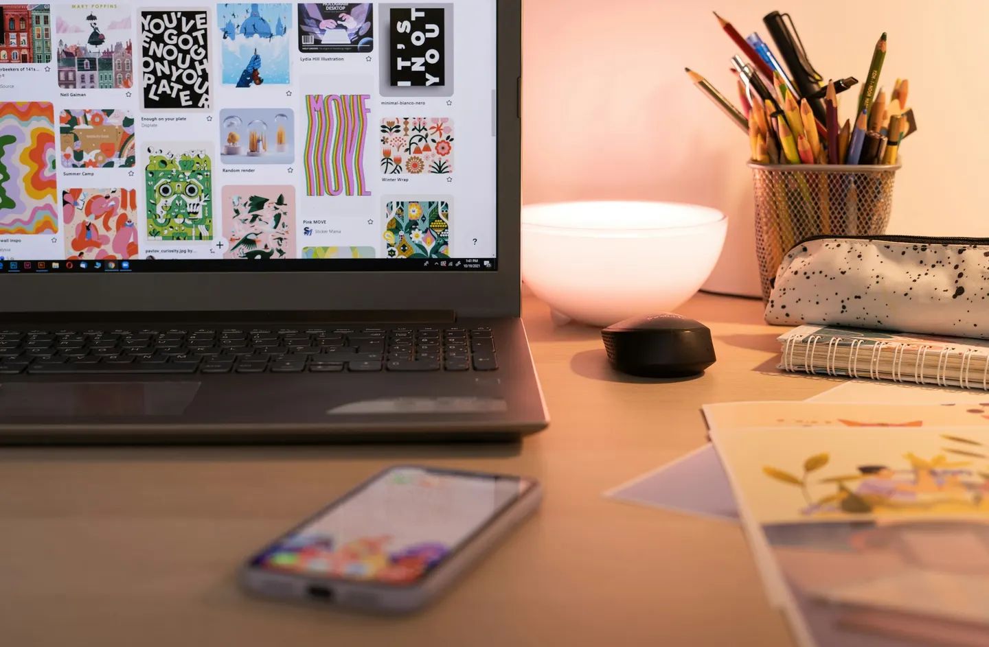 Laptop showing a pattern moodboard on a studio desk