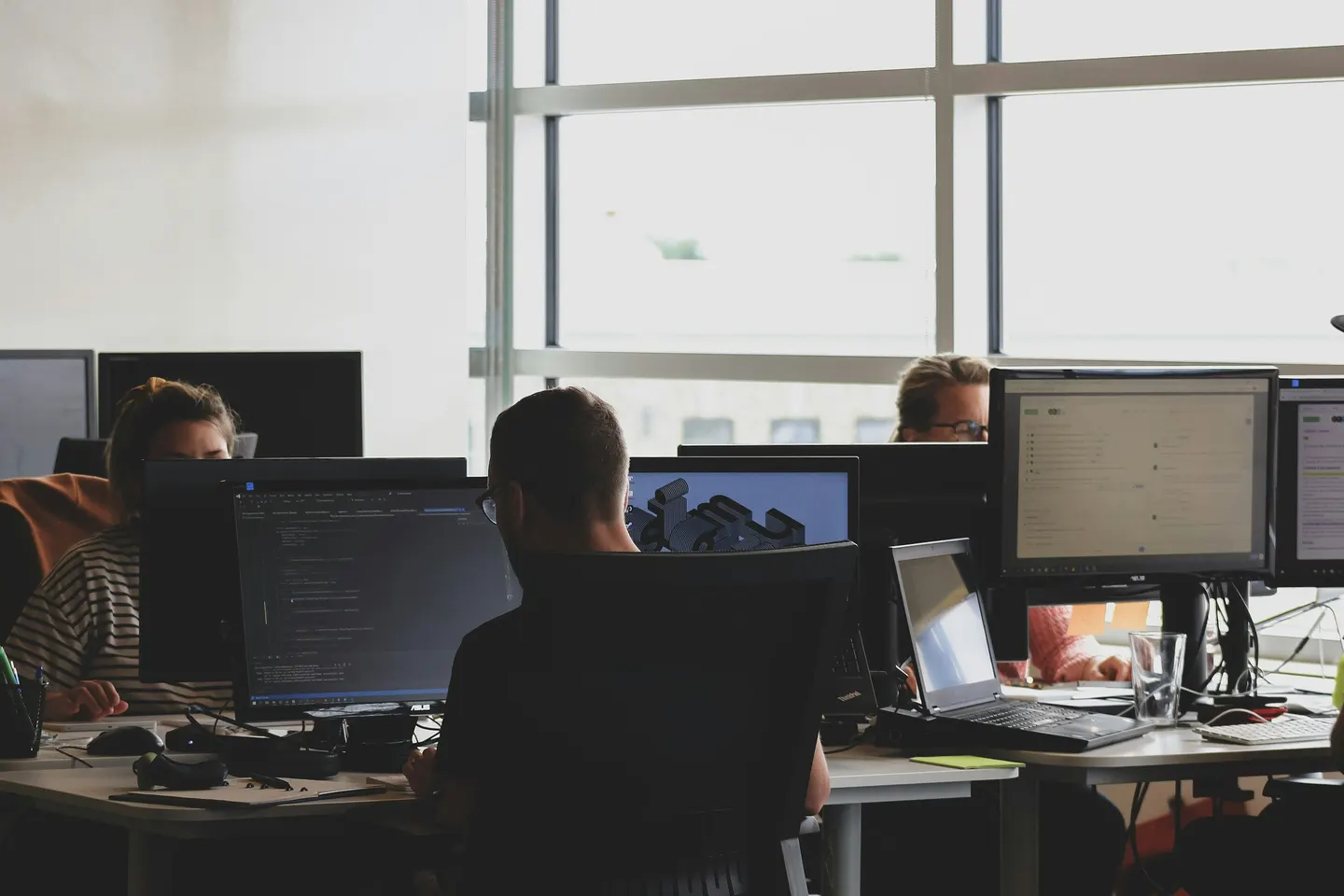 Studio team working at desks with monitors