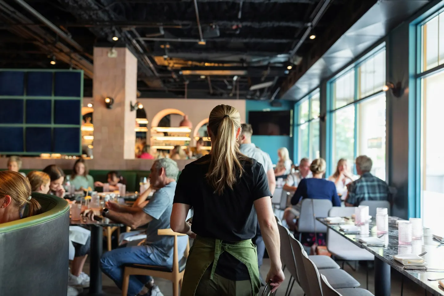 Busy restaurant with long shared tables