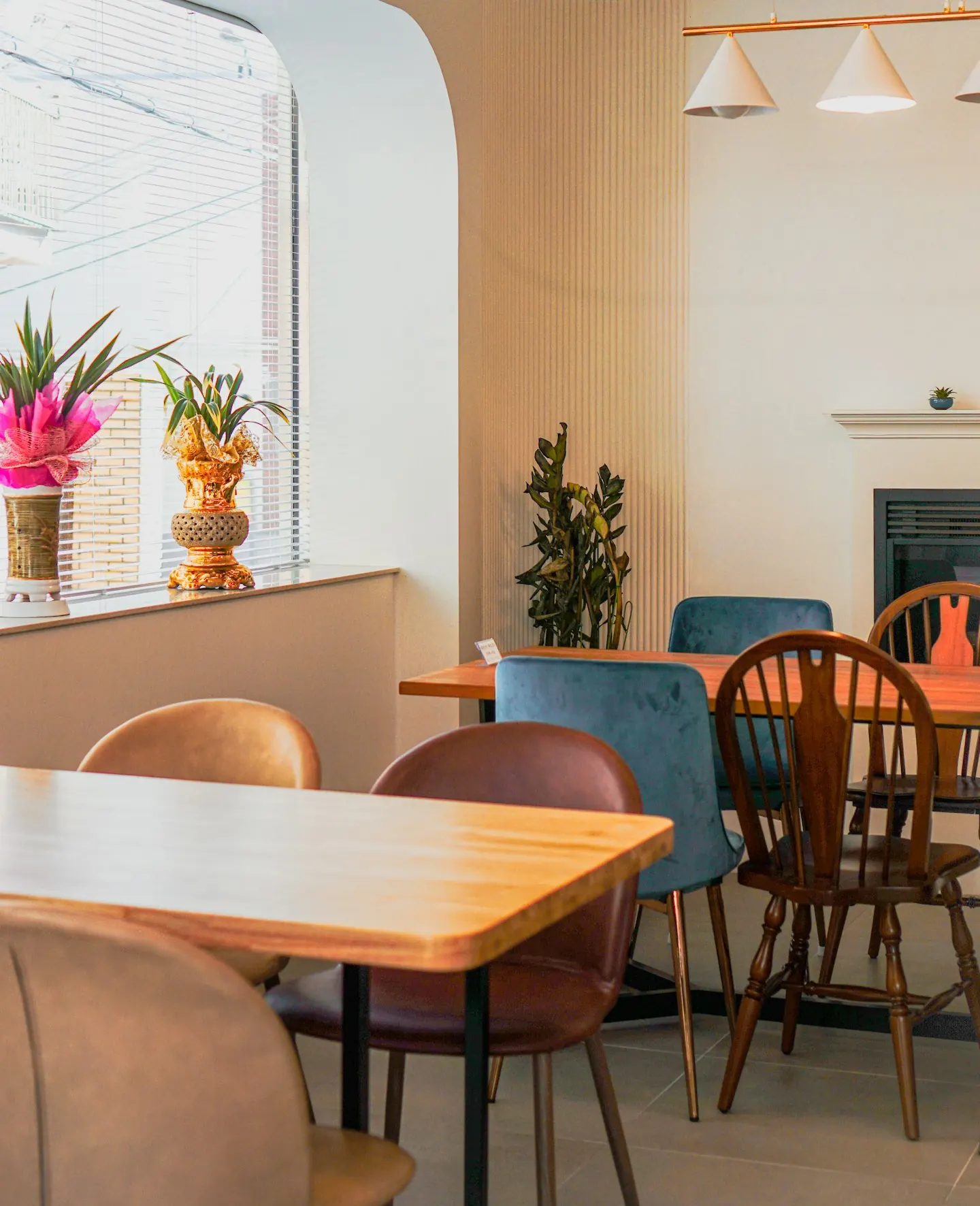 Bright café seating with wooden tables and mixed chairs