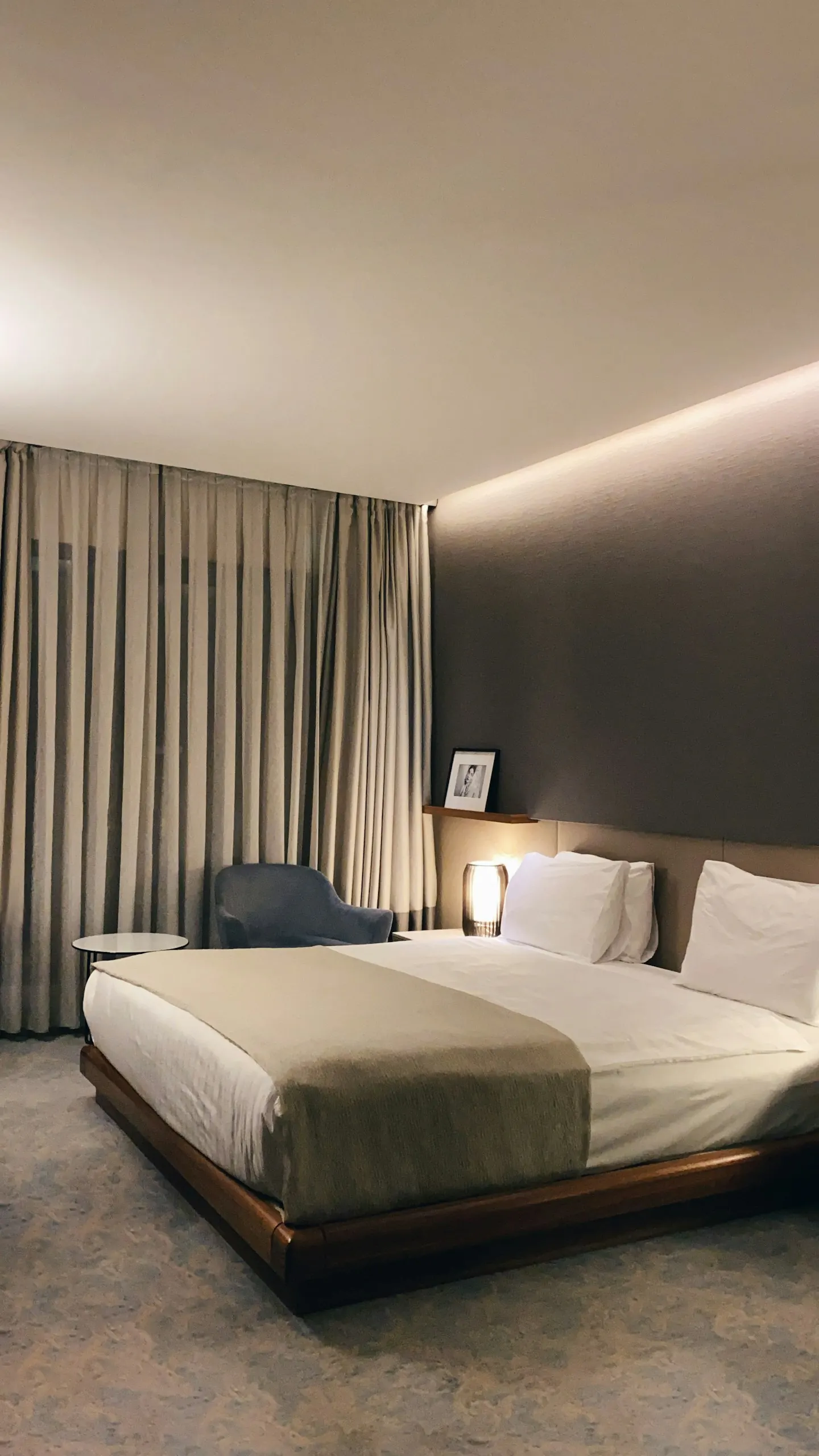 White bed with a grey pillow