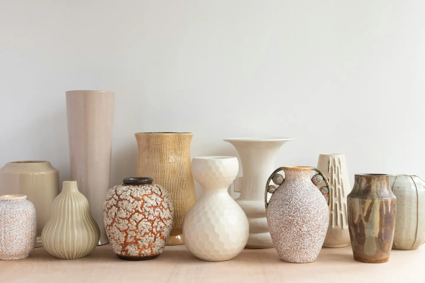 Ceramic vases arranged on a wooden surface