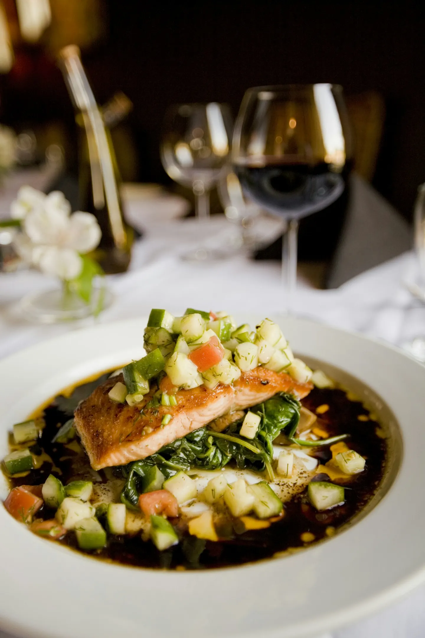 Salmon fillet served with salsa and red wine