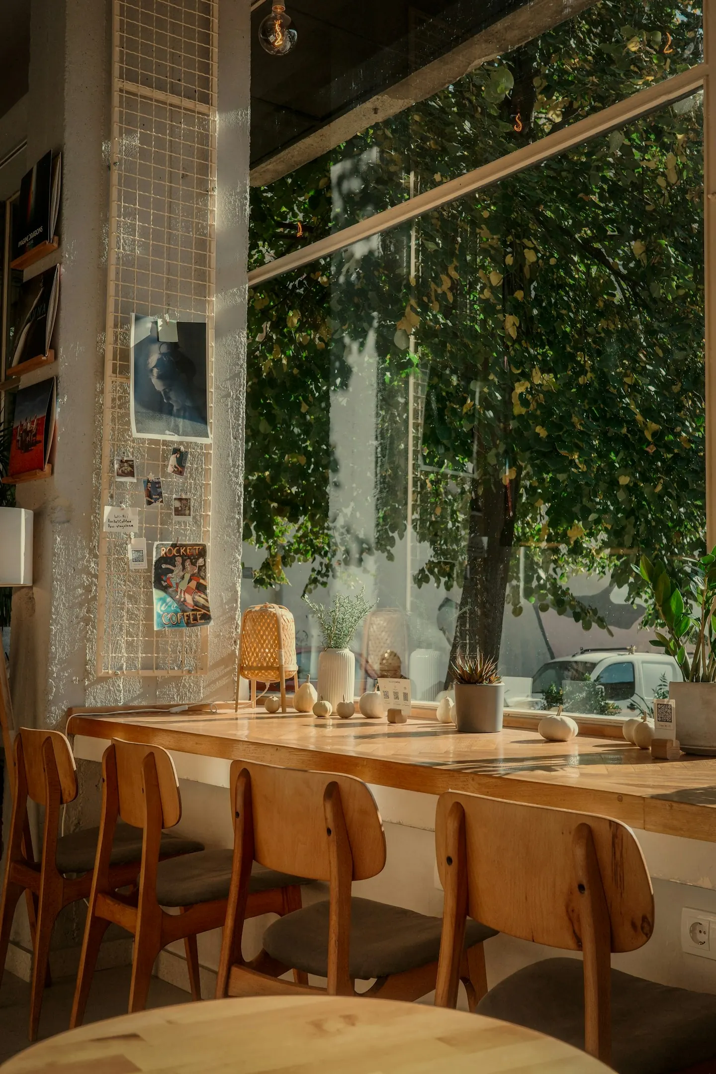 Dining table and chairs beside a large window